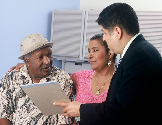 An insurance advisor explaining Medicare advantage plans in Fresno to an older adult.