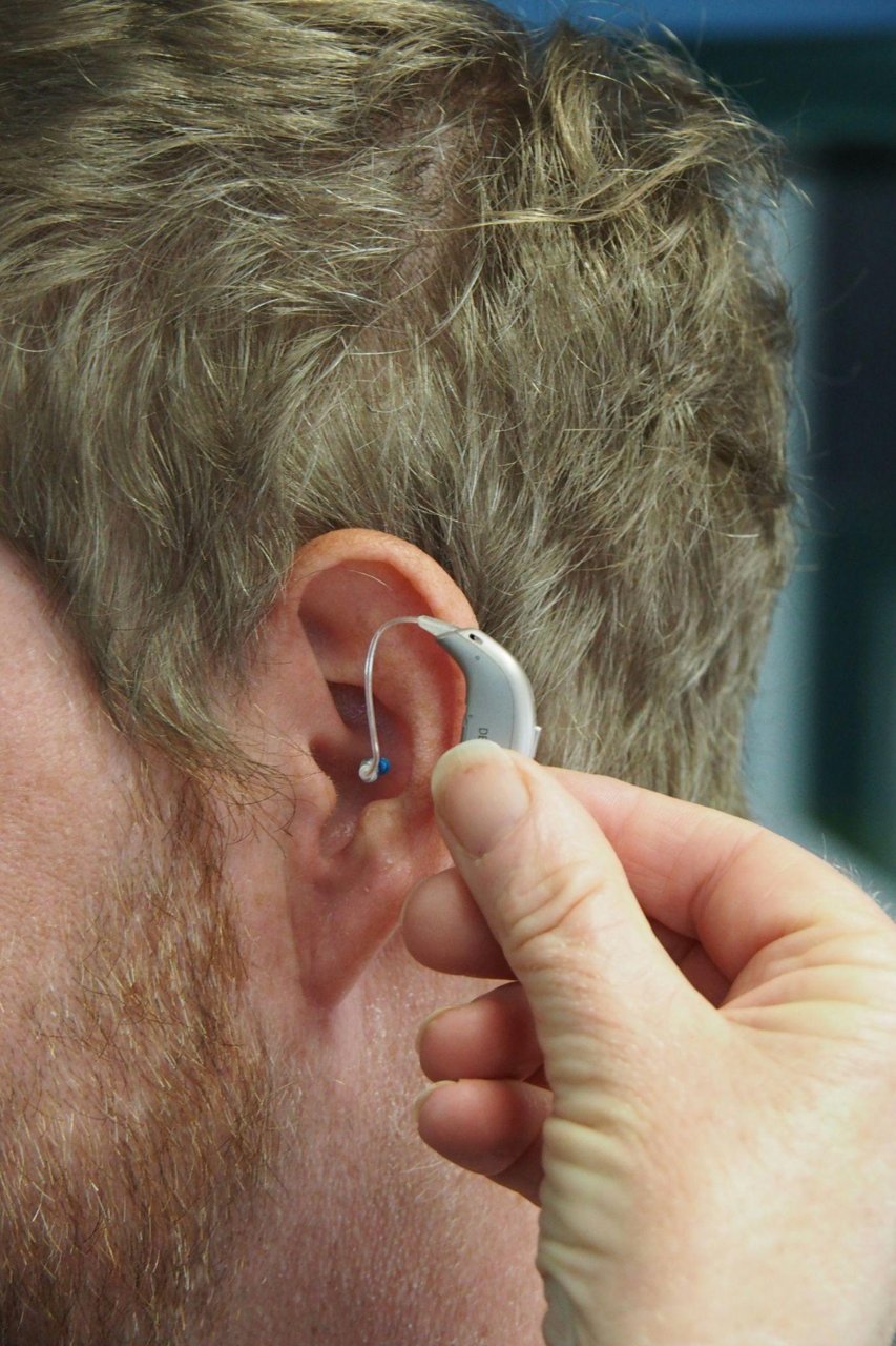 Hearing aid user exploring senior hearing insurance in California.