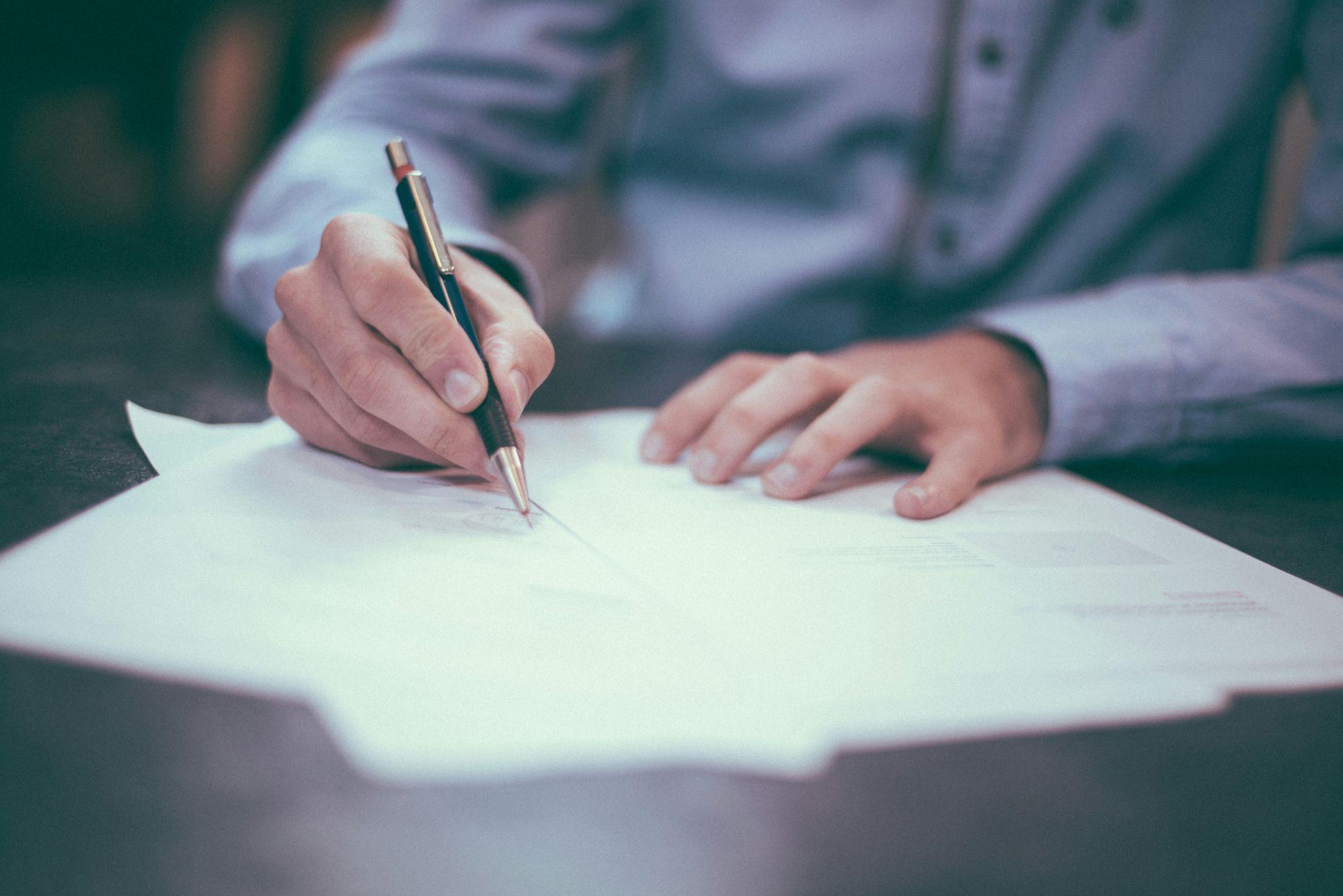 A person reviews documents with a life insurance broker in California.
