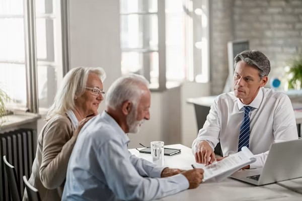 Senior discussing Medicare plans and insurance options with a professional