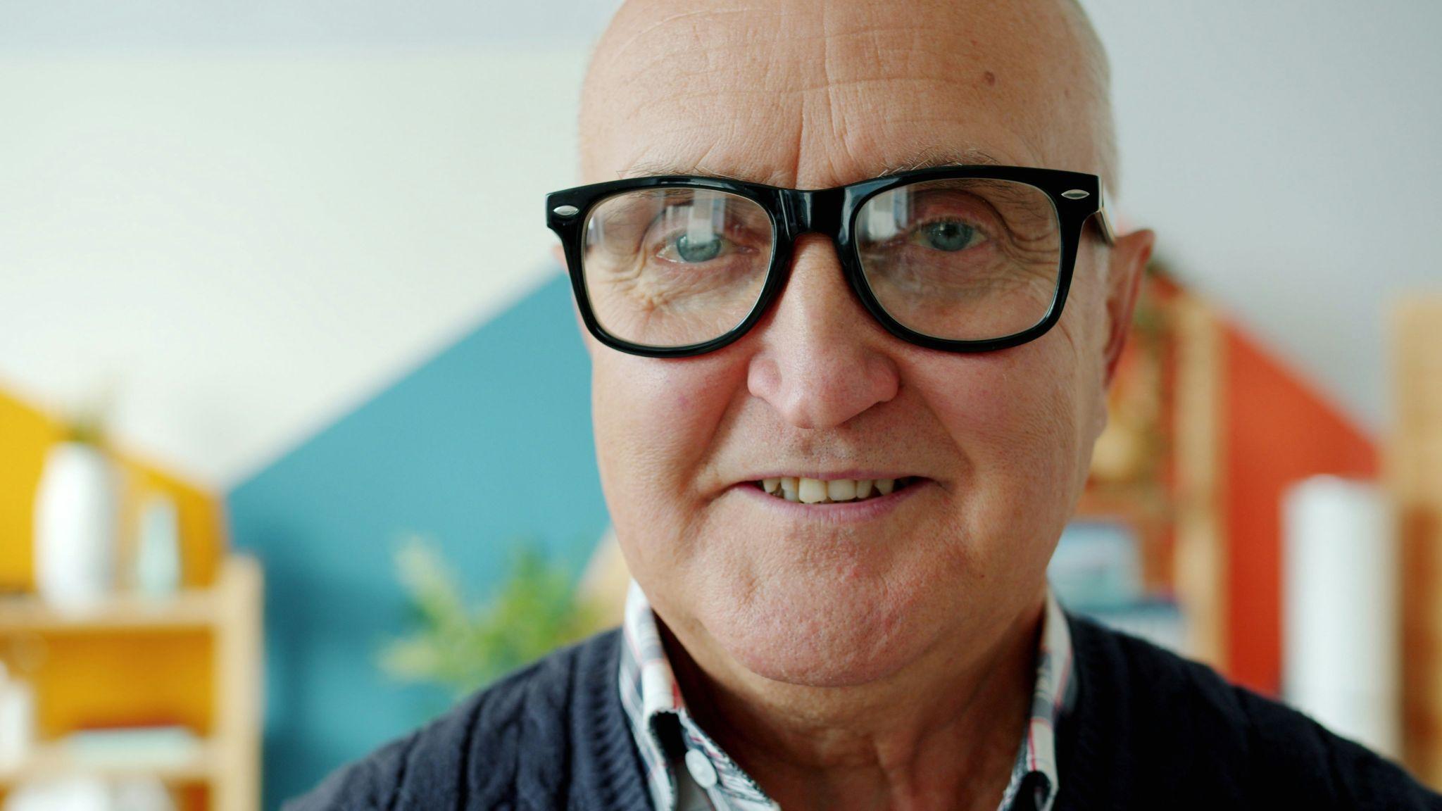 A close-up of a senior man wearing glasses highlighting vision insurance in California.